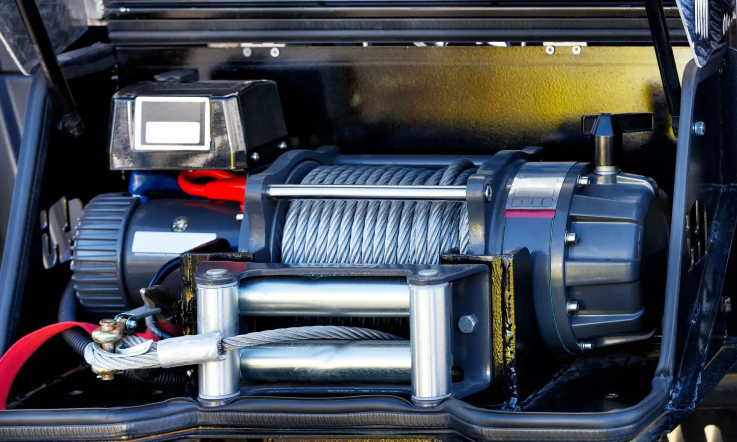 metallic cable of an electric winch in front of the cargo compartment of an equipped fire truck